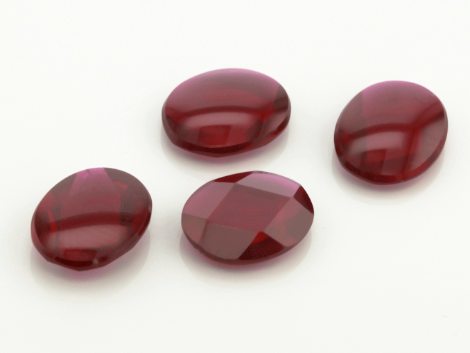 Synthetic/Lab Grown Ruby 10x8mm Oval Buff Top Faceted Back Dark Red